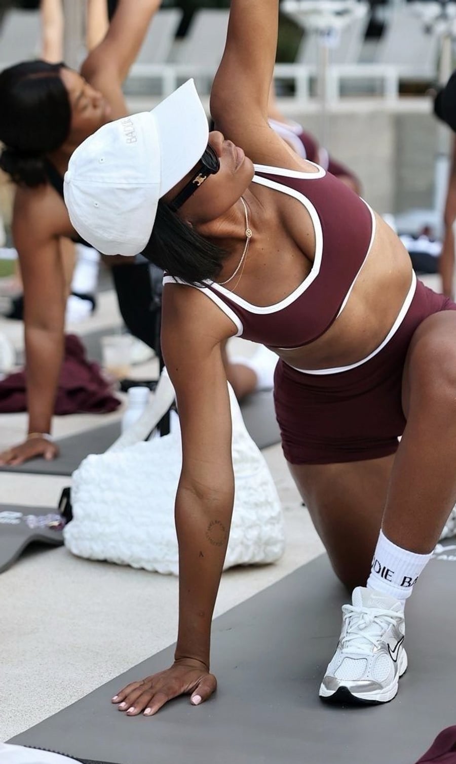 A member holding a side stretch on her mat during a BFF session